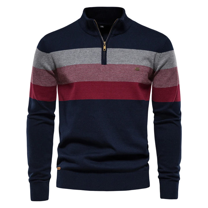 Navy, gray, and red striped pullover on a white studio backdrop.