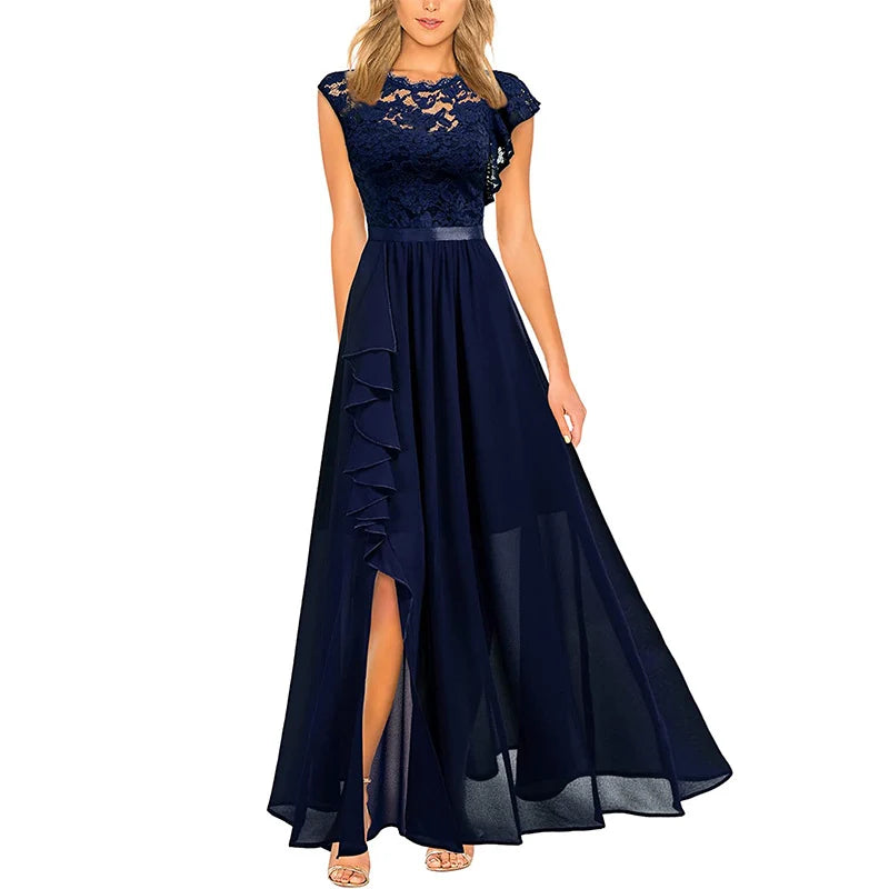Elegant navy blue dress with lace bodice and flowing skirt, featuring a ruffled slit, displayed on a model in studio setting.