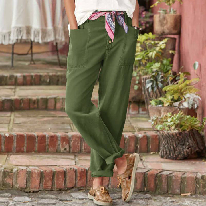 Green relaxed pants with scarf belt, featured on stone steps with greenery.