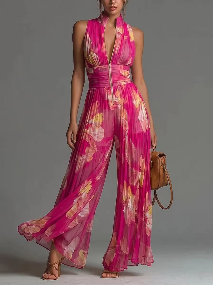 Pink floral jumpsuit with pleats and zip closure in studio setting.