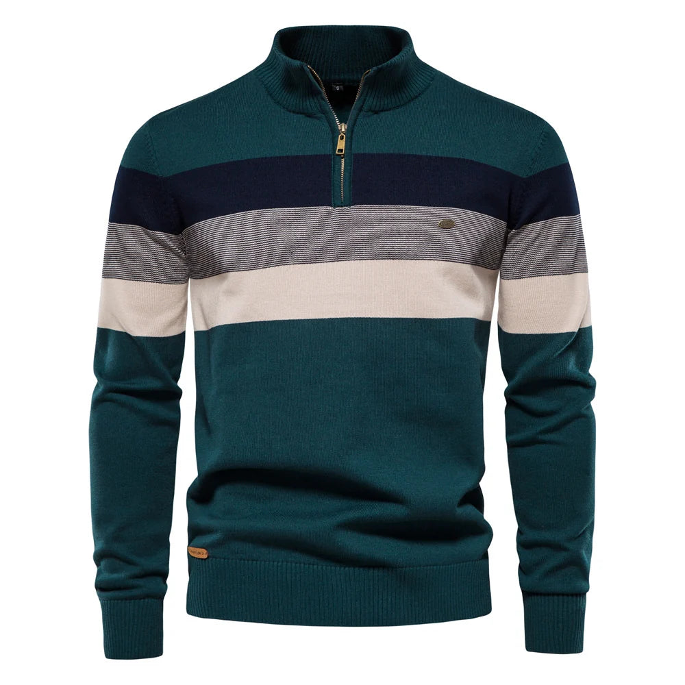 Teal, navy, and beige striped pullover against a white studio background.