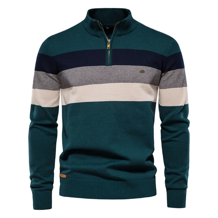 Teal, navy, and beige striped pullover against a white studio background.