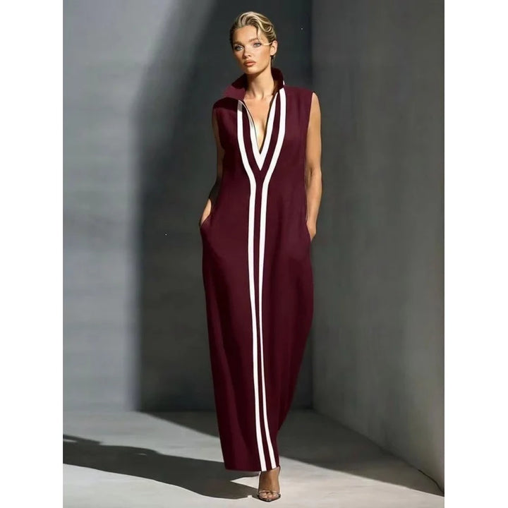 Sophisticated burgundy sleeveless maxi dress with white stripes in a minimalist indoor setting.