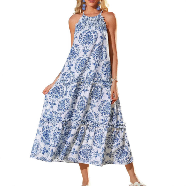 Blue and white patterned boho dress worn by a person, standing in a white studio setting.