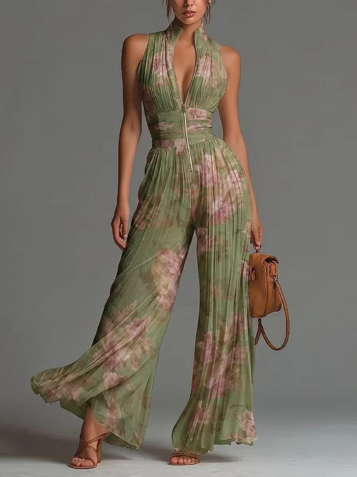 Green floral jumpsuit with pleated texture and zip detail in studio setting.