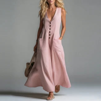 Pink maxi dress with buttons and pockets, worn by a model in a studio setting.
