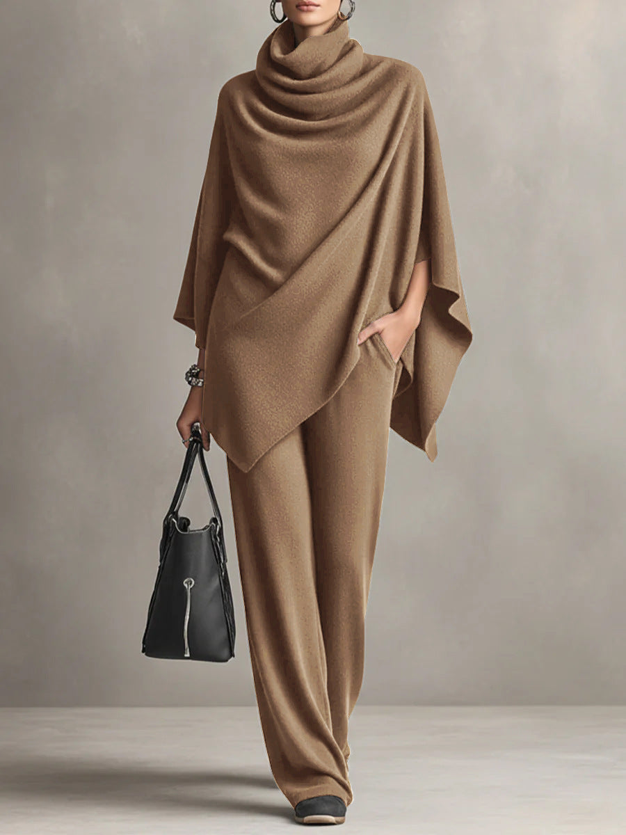 Tan two-piece set with elegant draped top and wide-leg pants in studio setting, accessorized with black handbag.