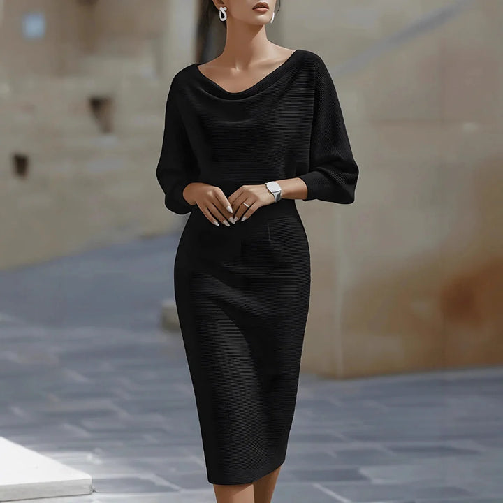 Chic black midi dress with a draped neckline and three-quarter sleeves, featured in an outdoor scene.