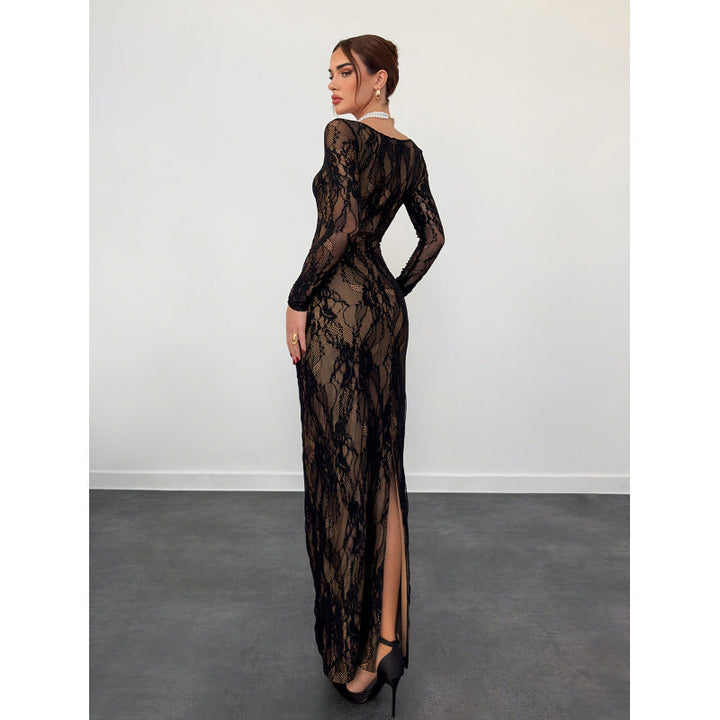 Model wearing a long, black lace dress with intricate patterns, standing in a studio against a plain white background.