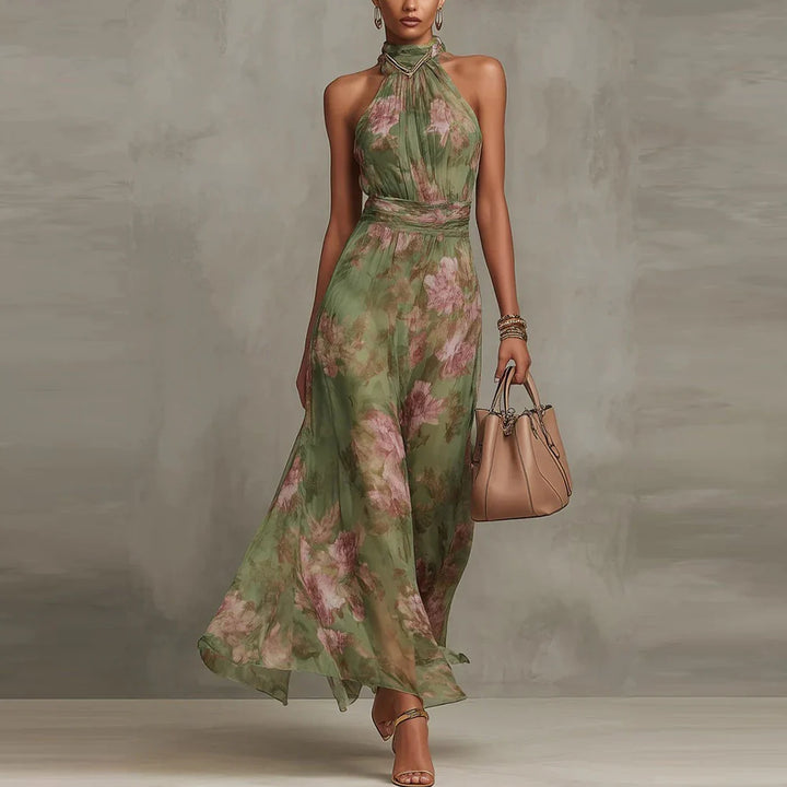 Green floral halter-neck maxi dress in studio setting with beige handbag.