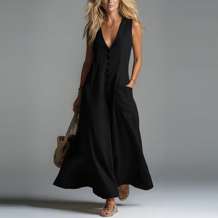 Black maxi dress with buttons and pockets, worn by a model in a studio setting.