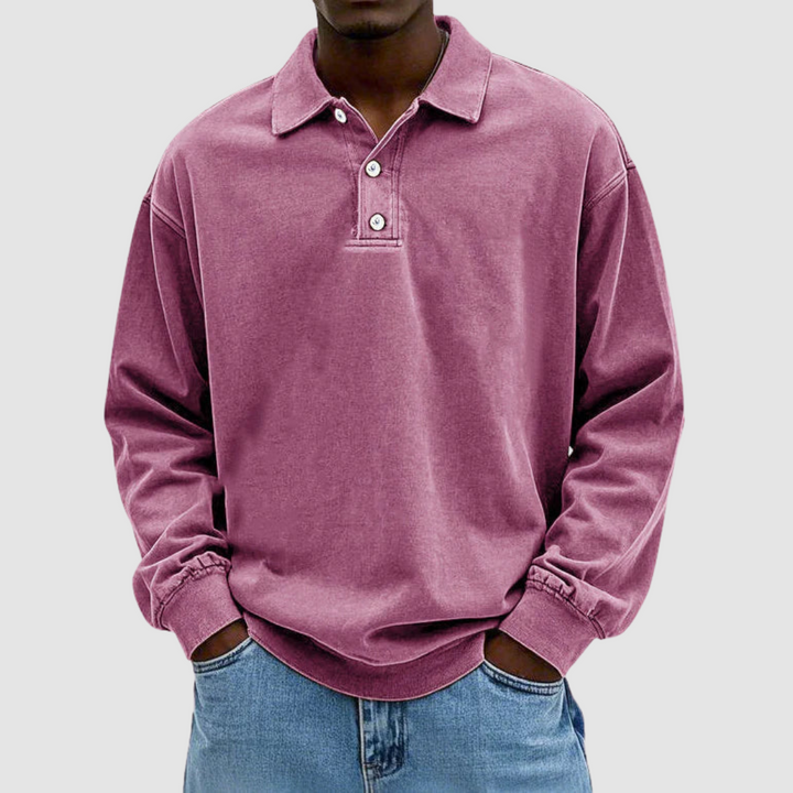 Pink vintage long sleeve polo shirt worn by model, hands in pockets, with light jeans, plain setting.