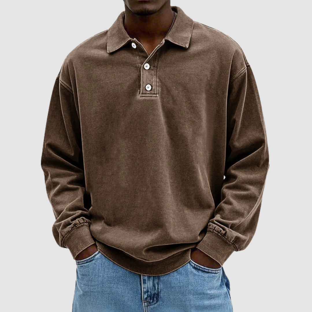 Brown vintage long sleeve polo shirt worn by model, hands in pockets, with light jeans, simple background.