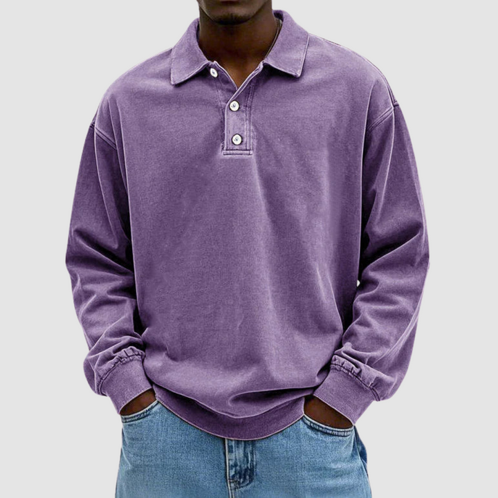 Purple vintage long sleeve polo shirt worn by model, hands in pockets, with light jeans, plain setting.