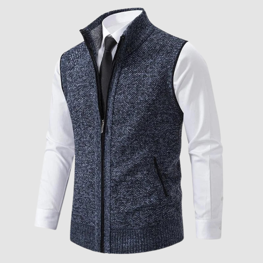 Dark blue fleece gilet displayed over white shirt and black tie in studio.