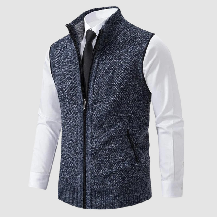 Dark blue fleece gilet displayed over white shirt and black tie in studio.