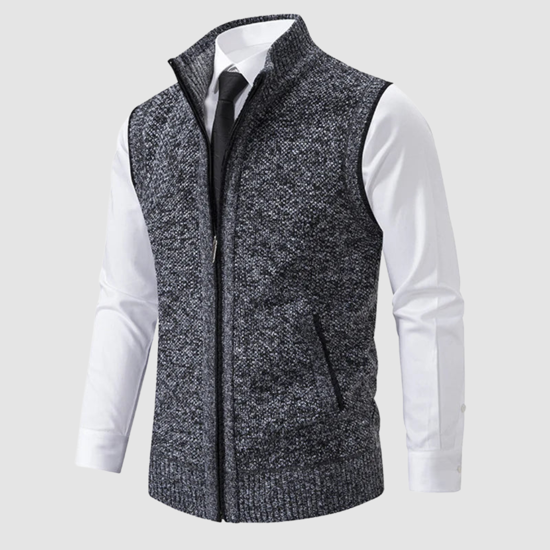 Dark gray fleece gilet displayed over white shirt and black tie in studio.