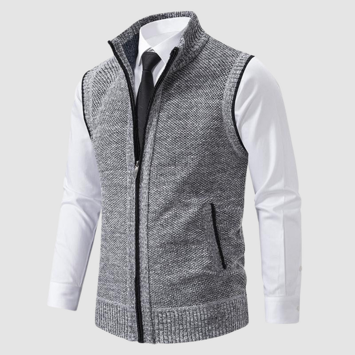Light gray fleece gilet displayed over white shirt and black tie in studio.