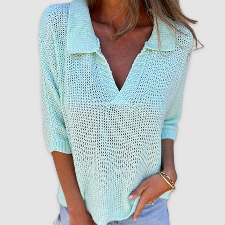 Mint green V-neck top with three-quarter sleeves styled with light blue jeans, set against a plain background.