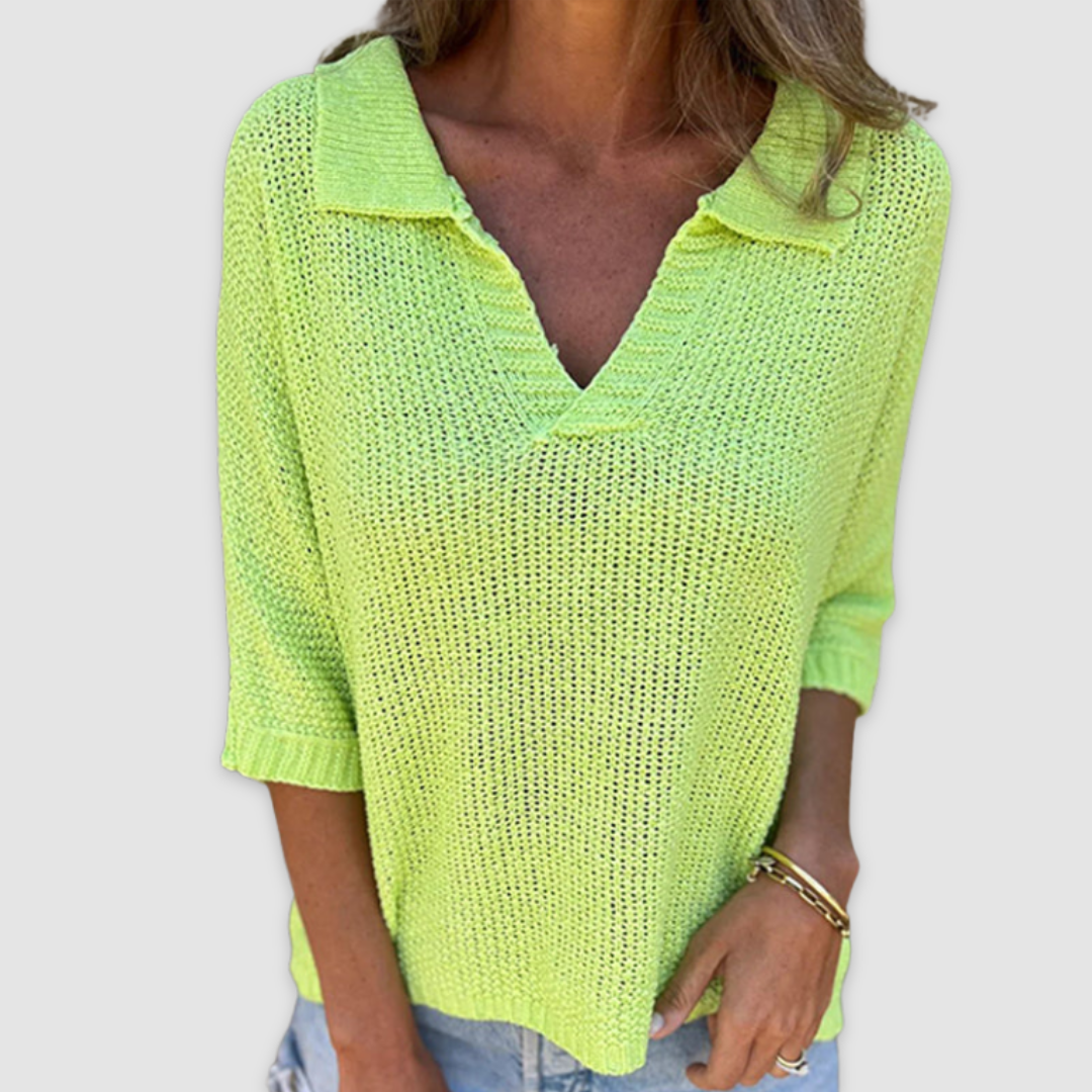 Bright yellow V-neck top with three-quarter sleeves paired with light blue jeans, on a plain background.