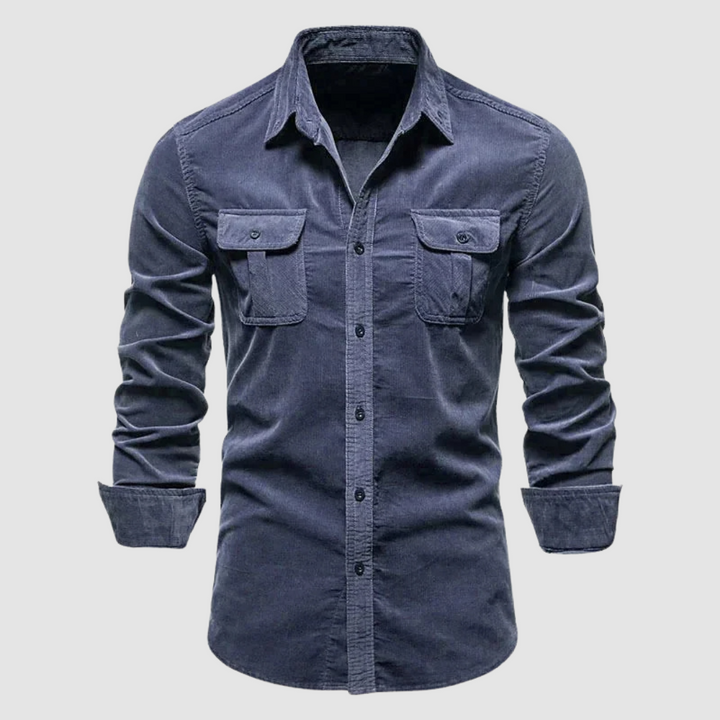 Dark blue corduroy shirt with buttoned flap pockets and a soft texture, displayed against a simple light background.