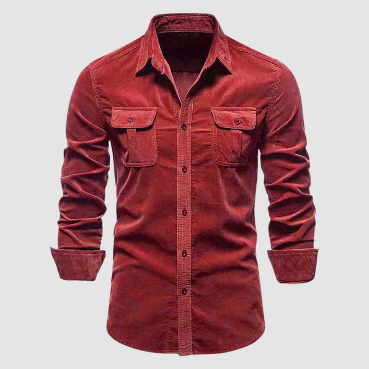 Red corduroy shirt featuring buttoned flap pockets and a collared design, set against a plain light background.