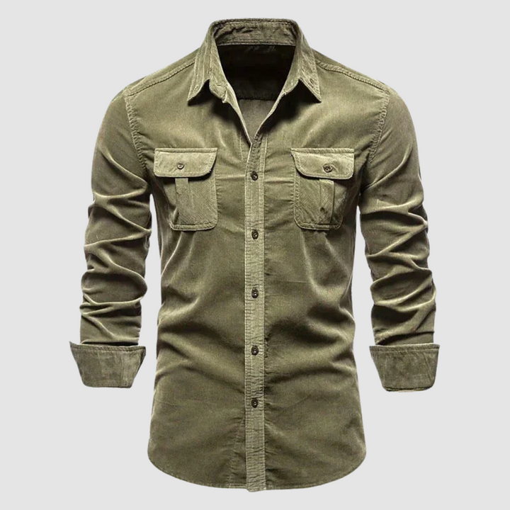 Olive green corduroy shirt with buttoned flap pockets and long sleeves displayed against a light gray background.