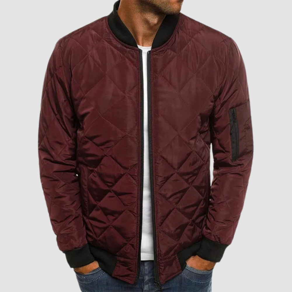 Burgundy quilted spring jacket with zipper and ribbed cuffs in studio setting.