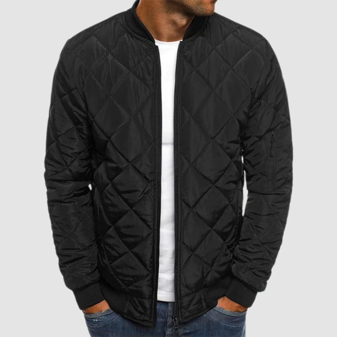 Black quilted spring jacket with zipper and ribbed cuffs in studio setting.