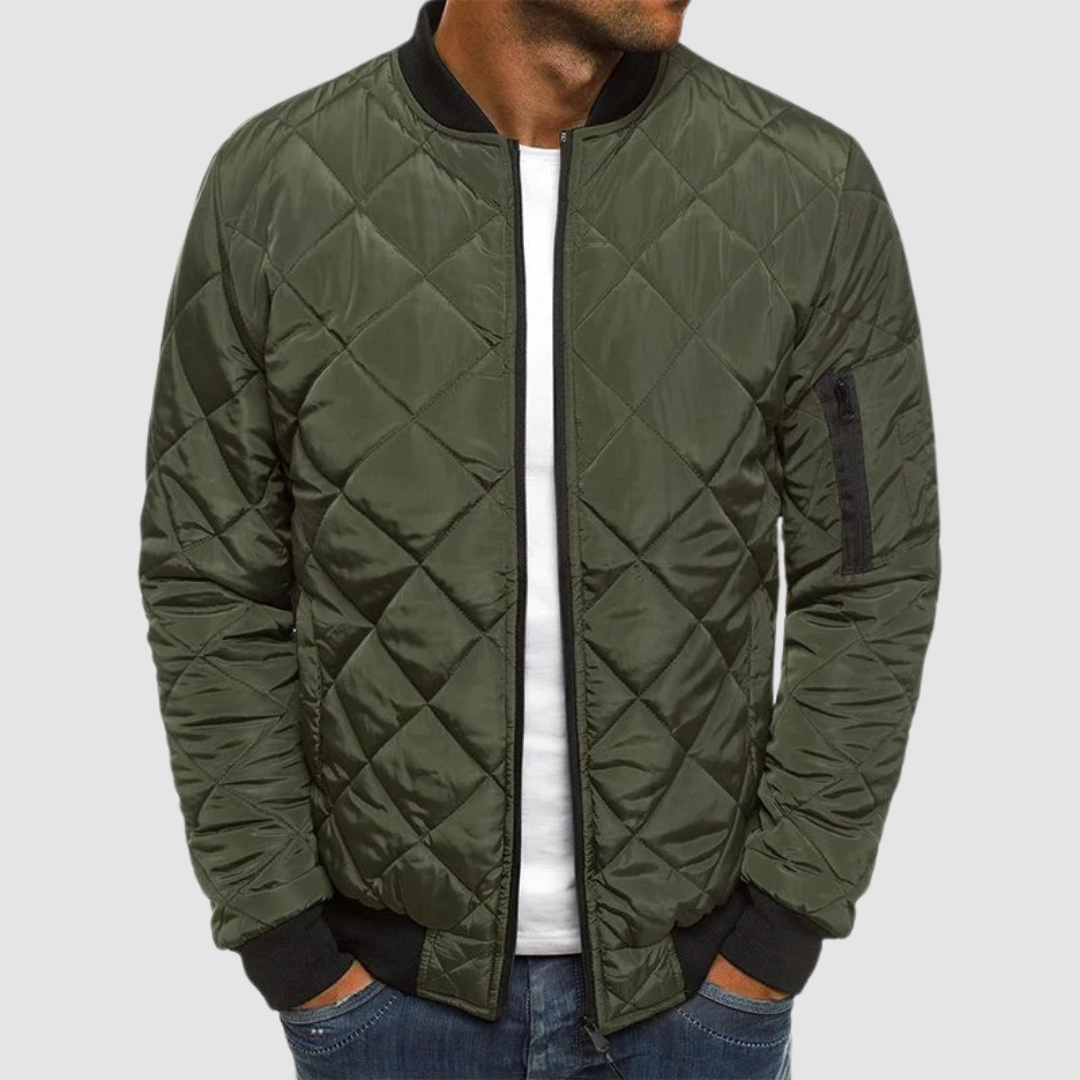 Olive green quilted spring jacket with zipper and ribbed cuffs in studio setting.