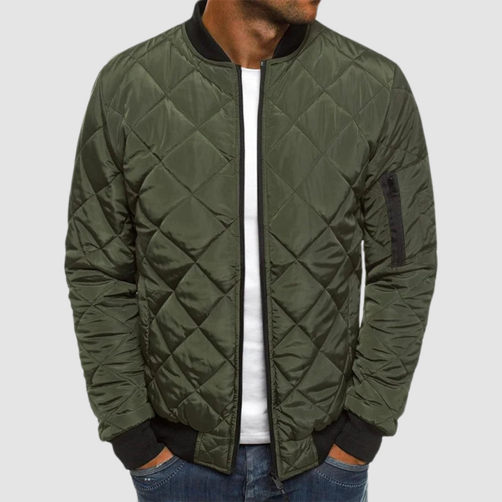 Olive green quilted spring jacket with zipper and ribbed cuffs in studio setting.