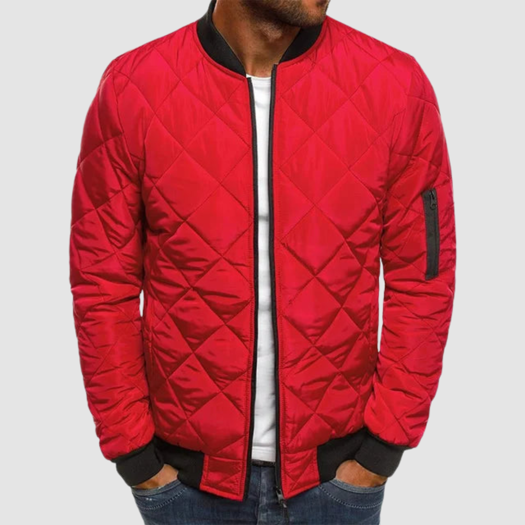 Red quilted spring jacket with zipper and ribbed cuffs in studio setting.