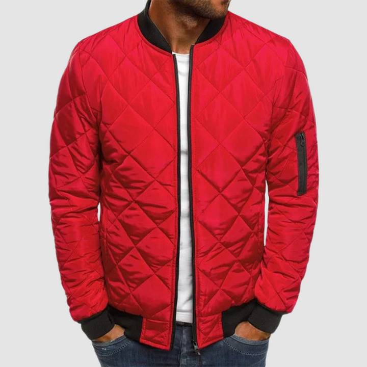 Red quilted spring jacket with zipper and ribbed cuffs in studio setting.