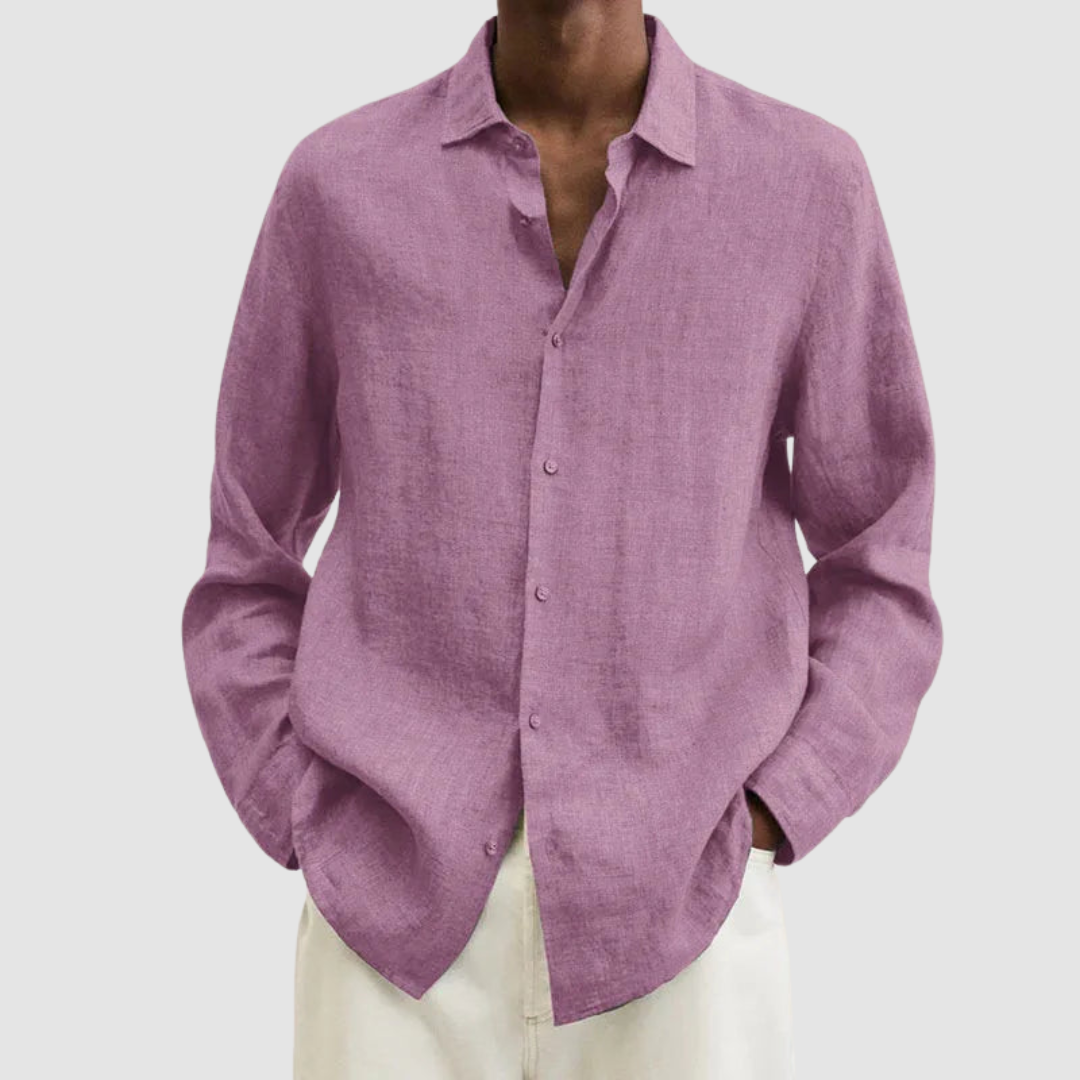 Model wearing a pink lightweight shirt with hands in pockets, against a light gray background.