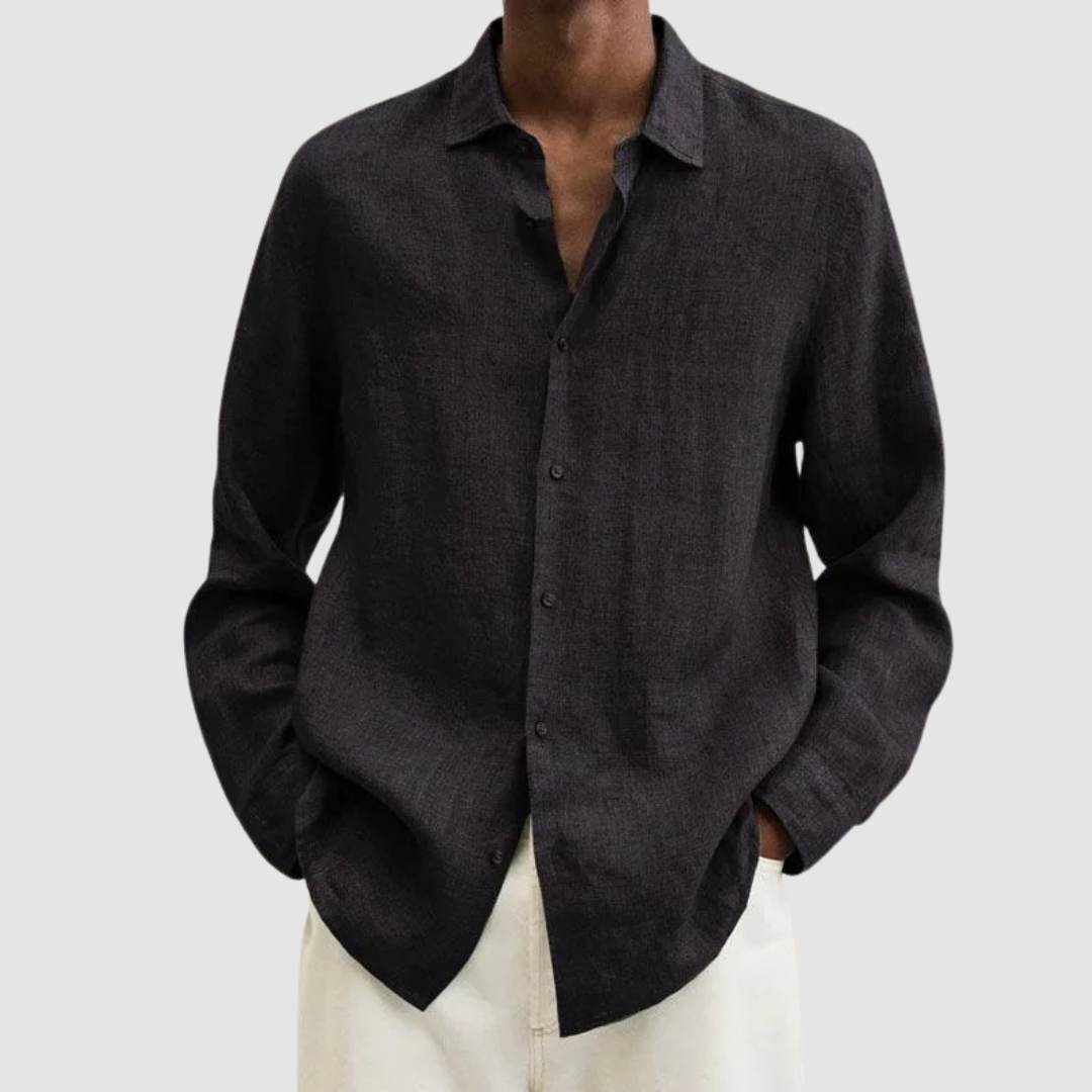 Model wearing a dark gray lightweight shirt with hands in pockets, against a light gray background.