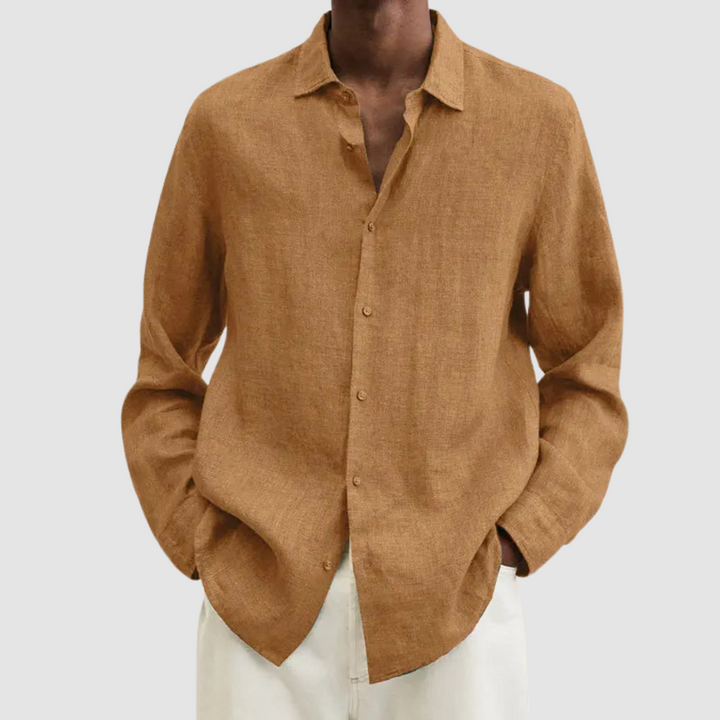 Model wearing a brown lightweight shirt with hands in pockets, against a light gray background.