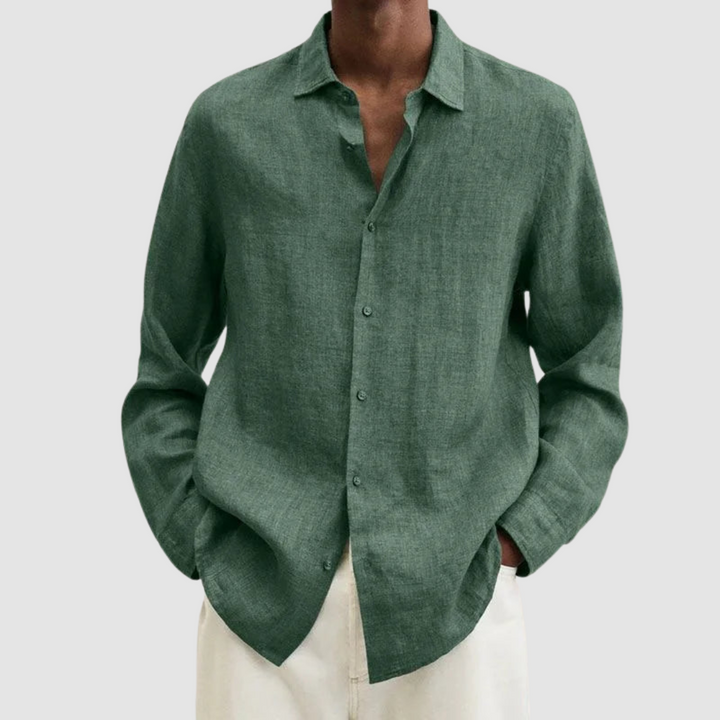 Model wearing a green lightweight shirt with hands in pockets, against a light gray background.