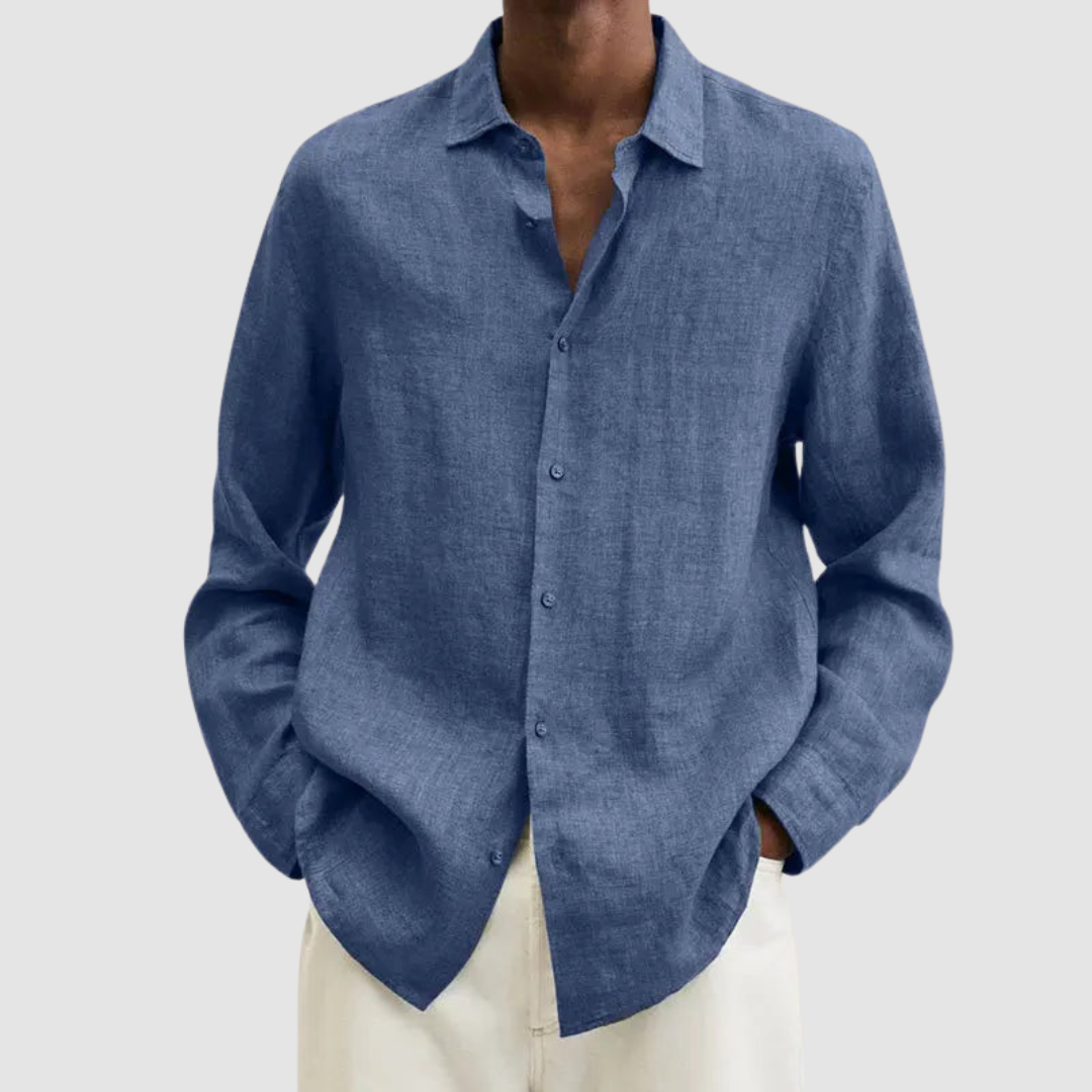 Model wearing a blue lightweight shirt with hands in pockets, against a light gray background.