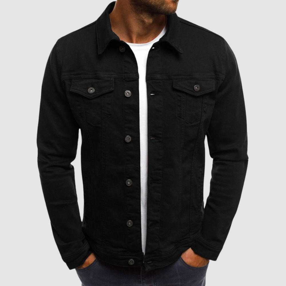 Model wearing a black jacket with button closure and chest pockets, paired with a white shirt, against a gray background.