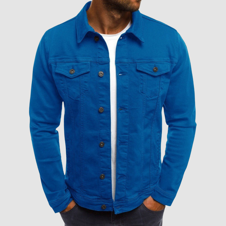 Model wearing a bright blue jacket with button closure and chest pockets, paired with a white shirt, against a gray background.
