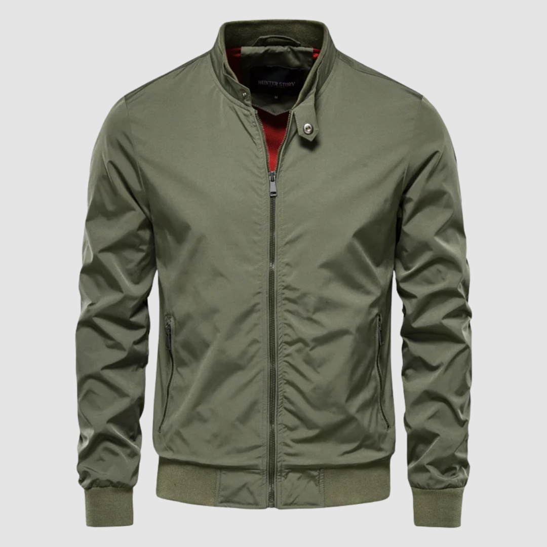 Front view of a green lightweight bomber jacket with a minimalist design on a grey background.