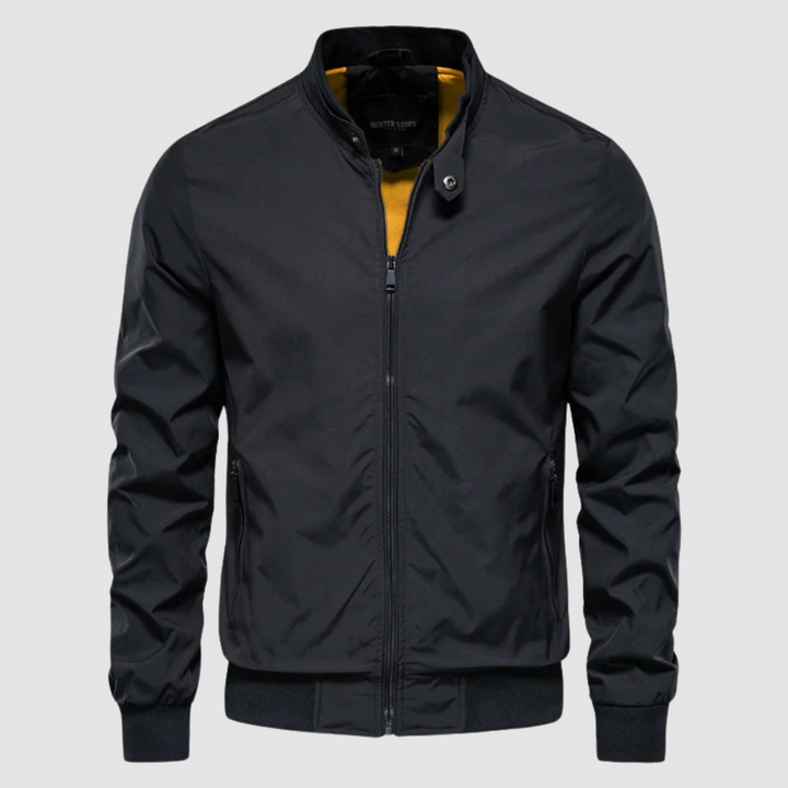 Front view of a dark navy lightweight bomber jacket with contrast interior on a grey background.