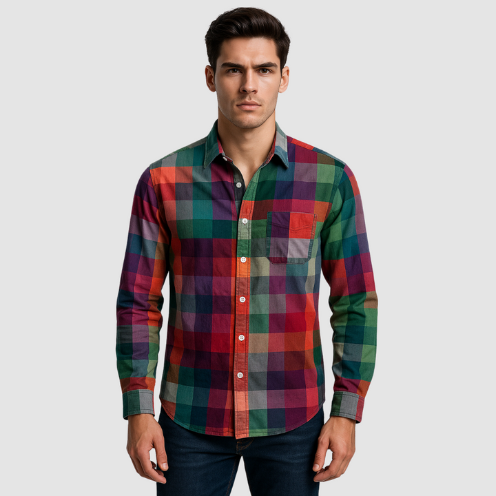 Man wearing a colorful checkered shirt with long sleeves, buttoned-up, and single front pocket. Plain light background.