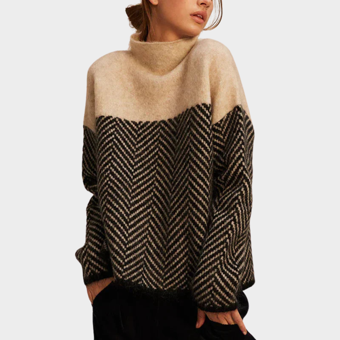 Two-tone, herringbone pattern sweater in beige and black, worn by woman, set against a plain background.