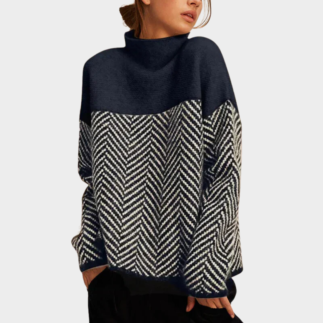 Two-tone, herringbone pattern sweater in dark blue and white, worn by woman, set against a plain background.