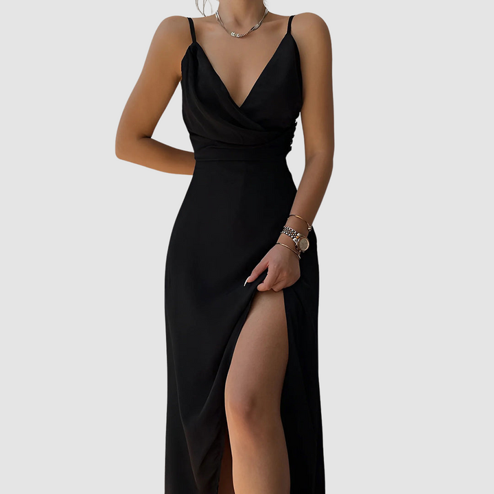 Chic black dress featuring a draped neckline and thigh-high slit, displayed in a studio setting.