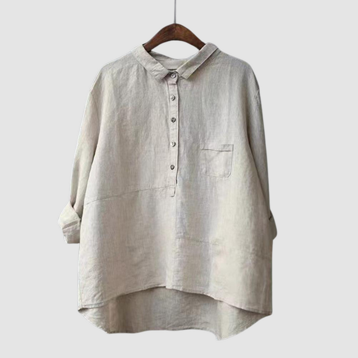 Light beige blouse on hanger with rolled sleeves, button-down front, and chest pocket against a light gray background.