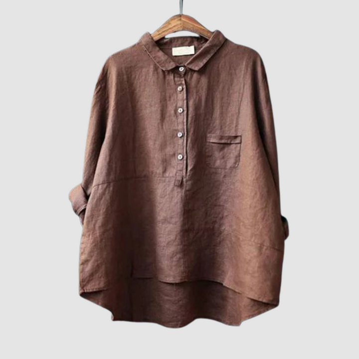 Rich brown blouse on hanger with rolled sleeves, button-down front, and chest pocket against a light gray background.