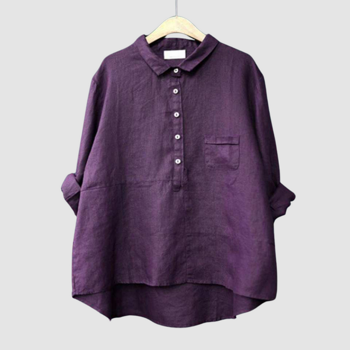 Deep plum blouse on hanger with rolled sleeves, button-down front, and chest pocket against a light gray background.