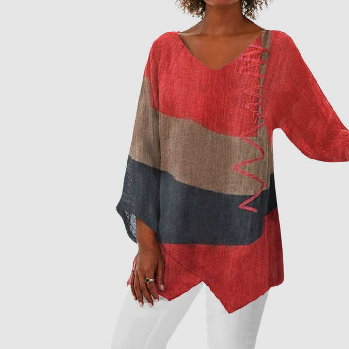 Vibrant red, brown, and black loose breathable shirt with asymmetrical hem in studio setting.